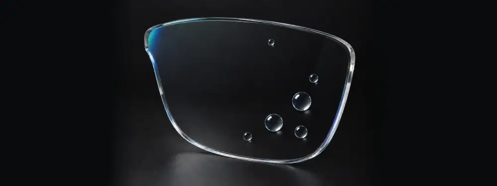 Klares entspiegeltes Glas mit kugelförmigen Wassertropfen auf der hydrophoben Beschichtung